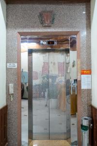 a glass door in a building with a picture of a woman at Hoàng Sơn Hải Hotel in Lạng Sơn