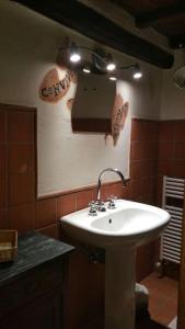 a bathroom with a white sink and a mirror at Convivio Etrusco in Bassano in Teverina +70 photos