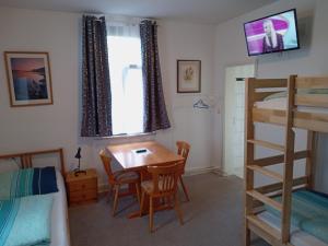 a bedroom with a desk and a bunk bed at Hotel Kremer in Büchenbeuren