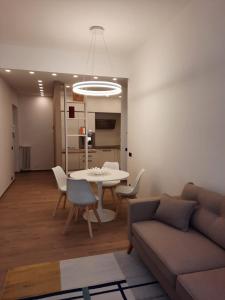 a living room with a couch and a table and chairs at APPARTAMENTO IL MARZOCCO in Pietrasanta