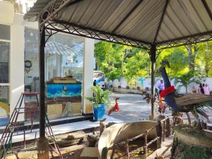 a painting of a house with two peacocks in a room at Thisara Pool Resort Kataragama & Yala & Kabiliththa Safari in Kataragama