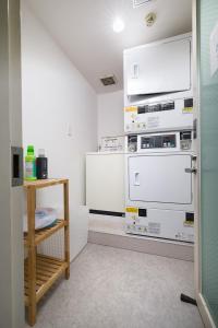 a kitchen with two refrigerators stacked on top of each other at Hotel Oak Shizuoka in Shizuoka