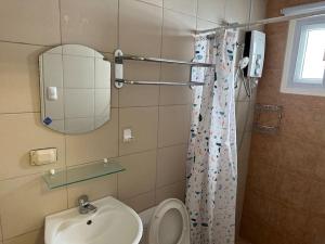 a bathroom with a toilet and a sink and a mirror at 4 Bedroom Bungalow, Angeles City in Angeles +19 photos