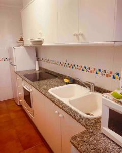 a kitchen with a sink and a counter top at Apartamento en primera línea de playa in Denia