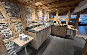 a kitchen with wooden walls and a counter with dishes at Hotel Adler Ittendorf in Ittendorf