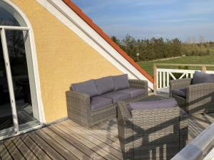 a patio with two chairs and a couch on a deck at Idyllic country house in Vadum