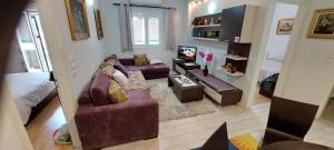A television and/or entertainment centre at Flora's Boutique Apartment at the heart of Corfu