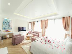 a bedroom with a bed and a living room at Phúc Thắng Hotel in Phú Quốc