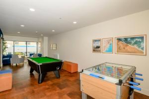 a living room with a pool table in it at 11 Putsborough - Luxury Apartment at Byron Woolacombe, only 4 minute walk to Woolacombe Beach! in Woolacombe