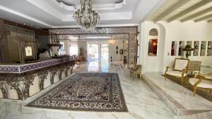 a living room with a lobby with a rug on the floor at Orpheas Resort Hotel (Adults Only) in Georgioupolis