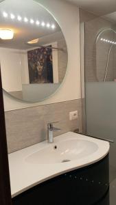 a bathroom with a white sink and a mirror at Casa del Sole in Narbolia