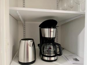a coffee maker and a coffeemaker sitting on a shelf at Travel Center Studio in Pori