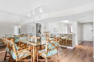 a dining room and kitchen with a table and chairs at Mainsail 176 in Destin