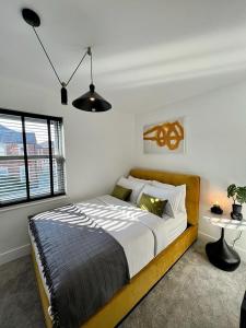 a bedroom with a bed and a large window at Charming 3-Bed House with 1 Parking space in Canterbury