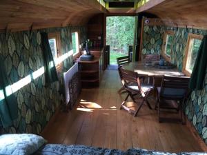 een kamer met een tafel en stoelen in een tiny house bij Ecostay de Wildernis in Wilp
