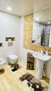 a bathroom with a sink and a toilet at Cosy Home in Rustavi