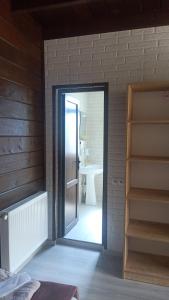 eine Tür, die in ein Bad mit einem Waschbecken führt in der Unterkunft Come & Rest in Kazbegi