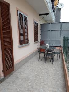 un patio con mesa, sillas y una valla en Stella, en Omegna
