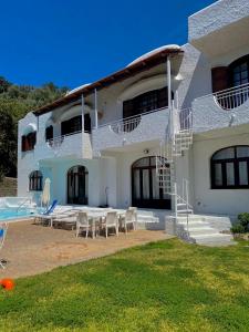 a large white house with a patio and a swimming pool at Villa Marecoco in Ischia