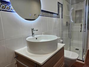 a white bathroom with a sink and a shower at 10A04 Casa Petacos in Pravia +38 photos