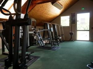 a gym with several tread machines in a room at HOME-COSY - 6 pers - 40 m2 3 CH - 2 SDB et 2 WC in Saint-Brevin-les-Pins