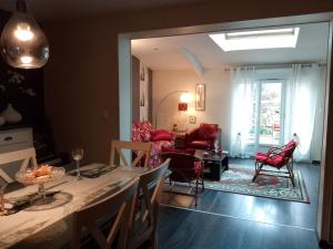 a kitchen and living room with a table and chairs at La tourterelle in La Rivière Saint Sauveur