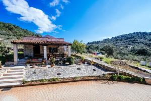 a house with a gazebo in the mountains at Roko Opaćac in Zadar