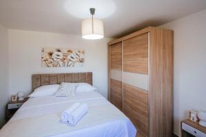 a bedroom with a bed with two towels on it at Roko Opaćac in Zadar