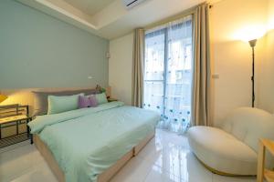 a bedroom with a bed and a chair and a window at SKYPIEA Villa 空島民宿 in Wujie