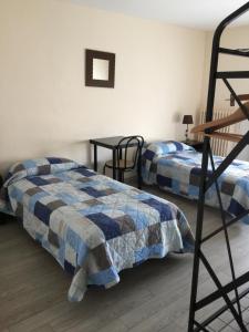 a bedroom with two beds and a bunk bed at Le Signoret in Sault-de-Vaucluse