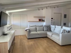 a living room with a couch and a television at cairoli7novate-mansarda in Novate Milanese