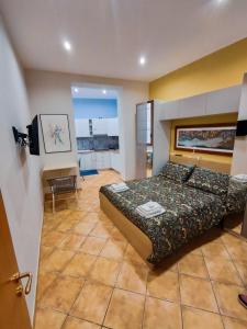 a bedroom with a bed and a desk in it at A casa di Chiara Salerno in Salerno