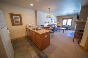 a kitchen with a sink and a living room at Red Hawk Lodge 2269 in Keystone