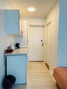 a kitchen with a counter and a hallway with a door at 4 minute walk to LEGO House - n4 in Billund
