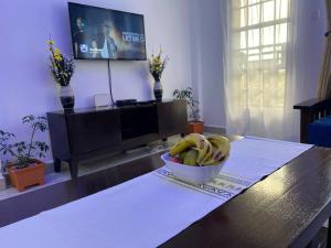 a bowl of bananas on a table in a living room at Levi's 1 Bedroom Apartment California Plaza Nanyuki in Nanyuki