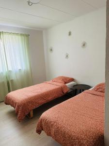 a room with two beds with red blankets and a window at 300 meter walk to Lego house - Door 9 in Billund