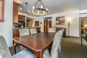 a dining room with a wooden table and chairs at Red Hawk Townhomes 2333 in Keystone