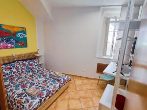 a bedroom with a bed and a desk and a window at A casa di Chiara Salerno in Salerno
