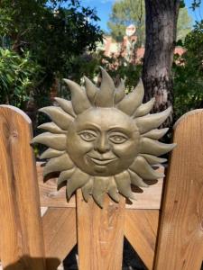 a metal sun head on a wooden fence at Casa del Sole in Narbolia