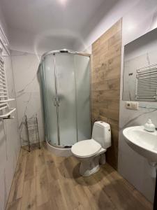 a bathroom with a shower and a toilet and a sink at Pokoje goscinne U Marynarza in Łeba +49 photos