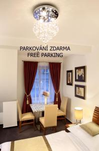 a dining room with a table and chairs and a chandelier at CK Pension in Český Krumlov