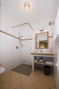 a bathroom with a sink and a mirror at Land-gut-Hotel Rohdenburg in Lilienthal