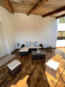 a living room with couches and a table at Casa Le Cicale in Porto Istana