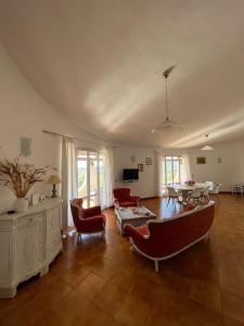 a living room with a couch and a table and chairs at Casa Le Cicale in Porto Istana