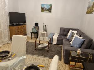 een woonkamer met een bank en een tv bij La perle Marine in Diano Marina