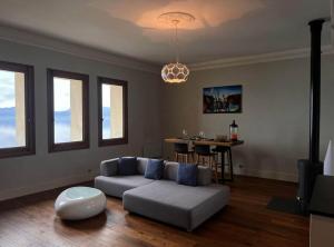 a living room with a couch and a table at Cabana & Nuit de Château au bord du Lac Léman in Lugrin