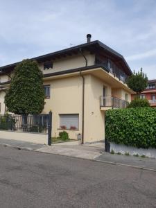 a white building with a balcony on a street at cairoli7novate-mansarda in Novate Milanese