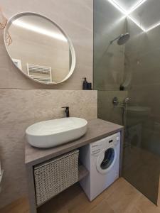a bathroom with a sink and a washing machine at Accommodation Iva in Zadar