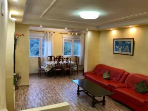 a living room with a red couch and a table at Casa Begur in Begur