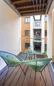 a patio with a table and chairs on a deck at 5 Putsborough - Luxury Apartment at Byron Woolacombe, only 4 minute walk to Woolacombe Beach! in Woolacombe